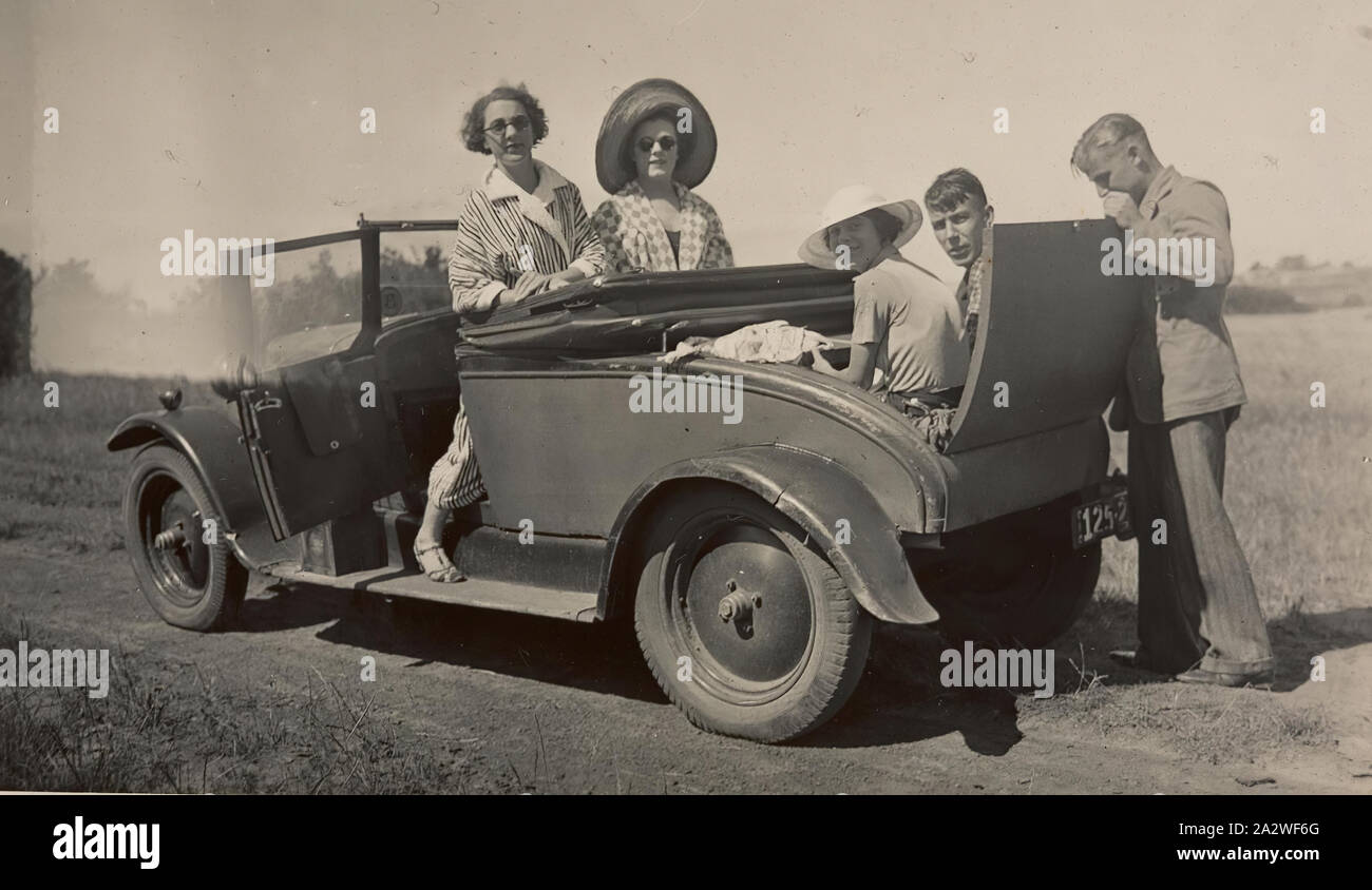 Digital Photograph - Young Couple Sitting in 'Dickie Seat' of Citroen Car on Family Drive, 1930s, Black and white photograph showing Ivy and Frederick Russell and friends, out for a Sunday drive, 1930's. Ivy and Frederick Russell were relegated to the back 'dickie' seat Stock Photo