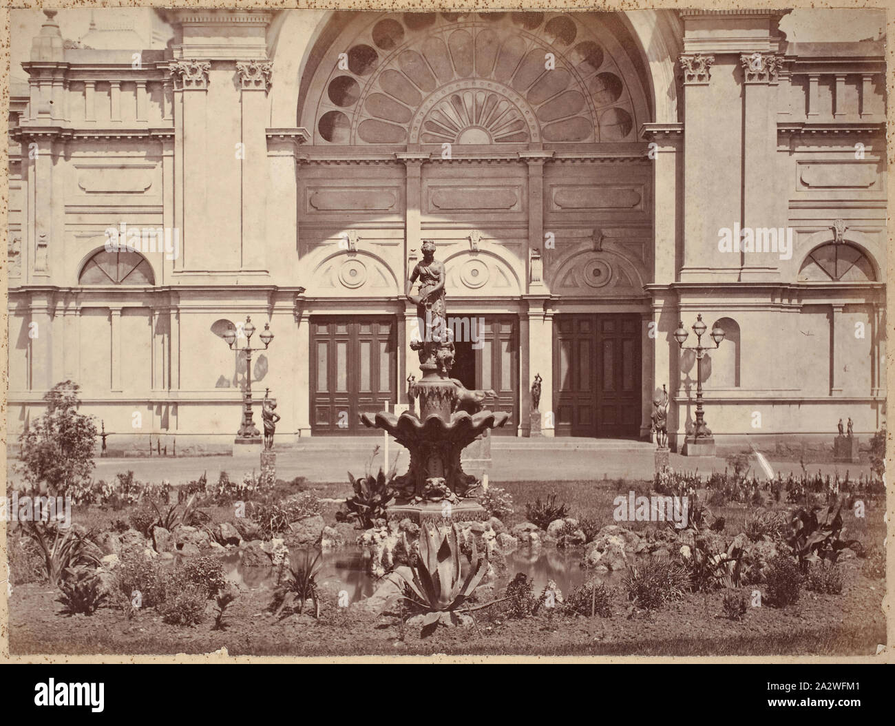 Photograph - French Fountain, Eastern Forecourt, Exhibition Building, 1880-1881, View of the original French Fountain in the eastern forecourt of the Exhibition Buildings, Carlton Gardens, between 1 October 1880 and 30 April 1881. Although it is unclear when the fountain was removed, photographs showing the eastern forecourt in the early twentieth century already reveal that the fountain had been replaced by the current design, manufactured by Antoine Durenne. This is one of Stock Photo