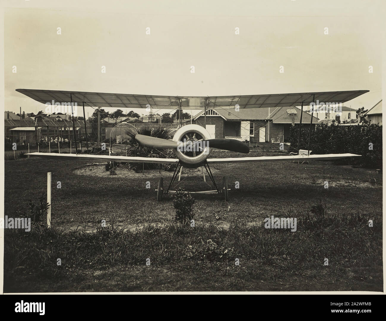 Photograph - Front View of Basil Watson's Biplane on the Rear Lawn Outside 'Foilacleugh', Elsternwick, Victoria, 1916, Part of a commemorative photograph album produced by Sears' Studios, Melbourne, documenting the work of Basil Watson in constructing a biplane at his family's home 'Foilacleugh' in Elsternwick, Victoria, during 1916, and the aftermath of his fatal crash off Point Cook on 28th March 1917. The biplane was based on the design of the Sopwith Pup Stock Photo