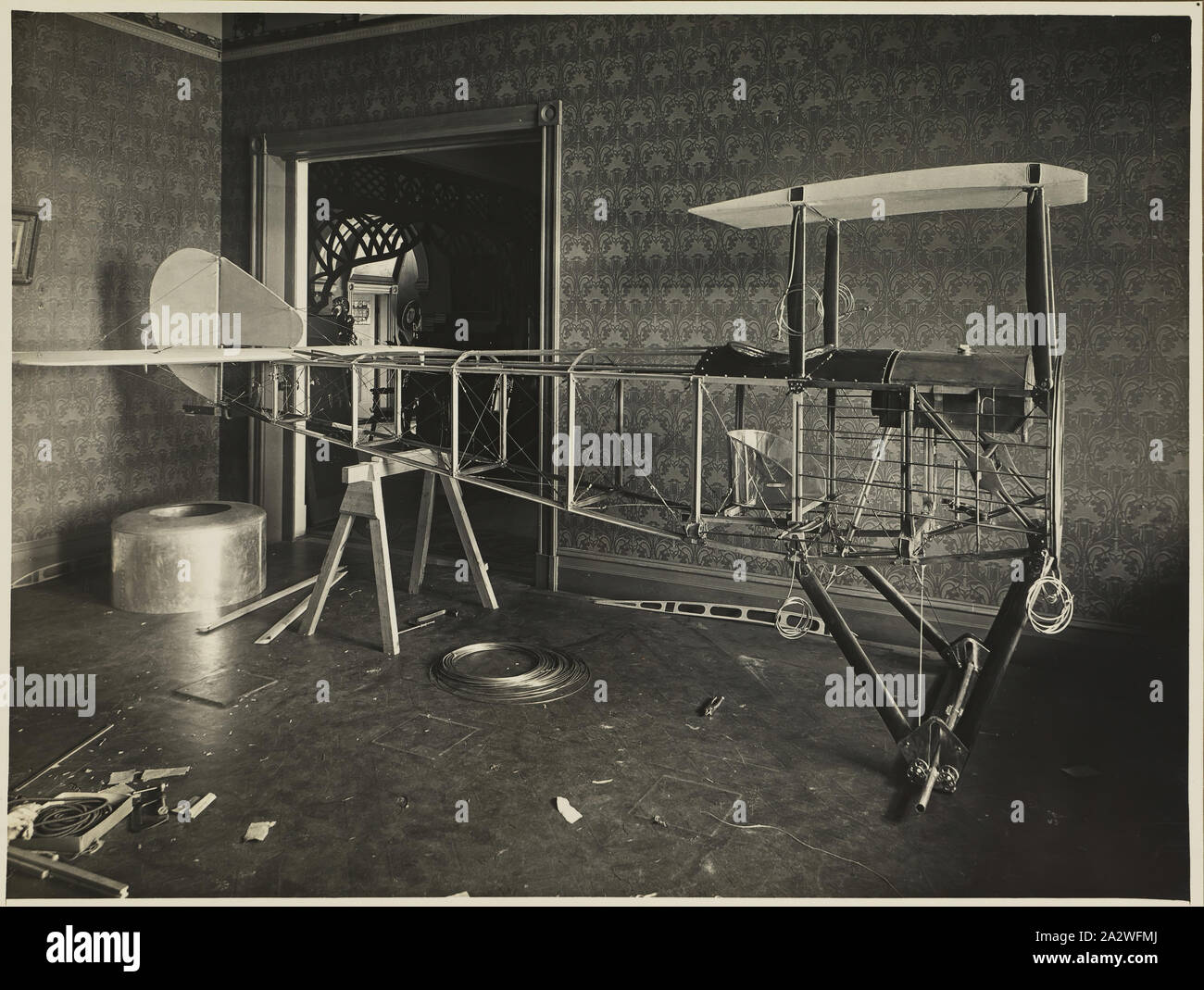 Photograph - Fuselage of Basil Watson's Partially Constructed Biplane in the Family Home, Elsternwick, Victoria, 1916, Part of a commemorative photograph album produced by Sears' Studios, Melbourne, documenting the work of Basil Watson in constructing a biplane at his family's home 'Foilacleugh' in Elsternwick, Victoria, during 1916, and the aftermath of his fatal crash off Point Cook on 28th March 1917. The biplane was based on the design of the Sopwith Pup Stock Photo