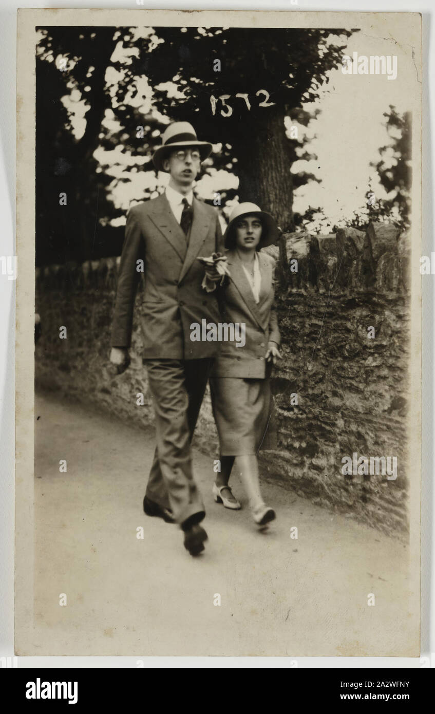 Photograph - George & Gertie Palmer Walking, Ilfracombe, England, circa 1930, Black and white photograph of George and Gertrude Palmer, in England circa1930. It may have been taken by a street photographer in Ilfracombe (the address of the photographer) during their honeymoon. It was brought to Australia by George Palmer when he migrated to Australia from England with his wife Gertrude and their two daughters, Shirley and Lesley in 1947 Stock Photo