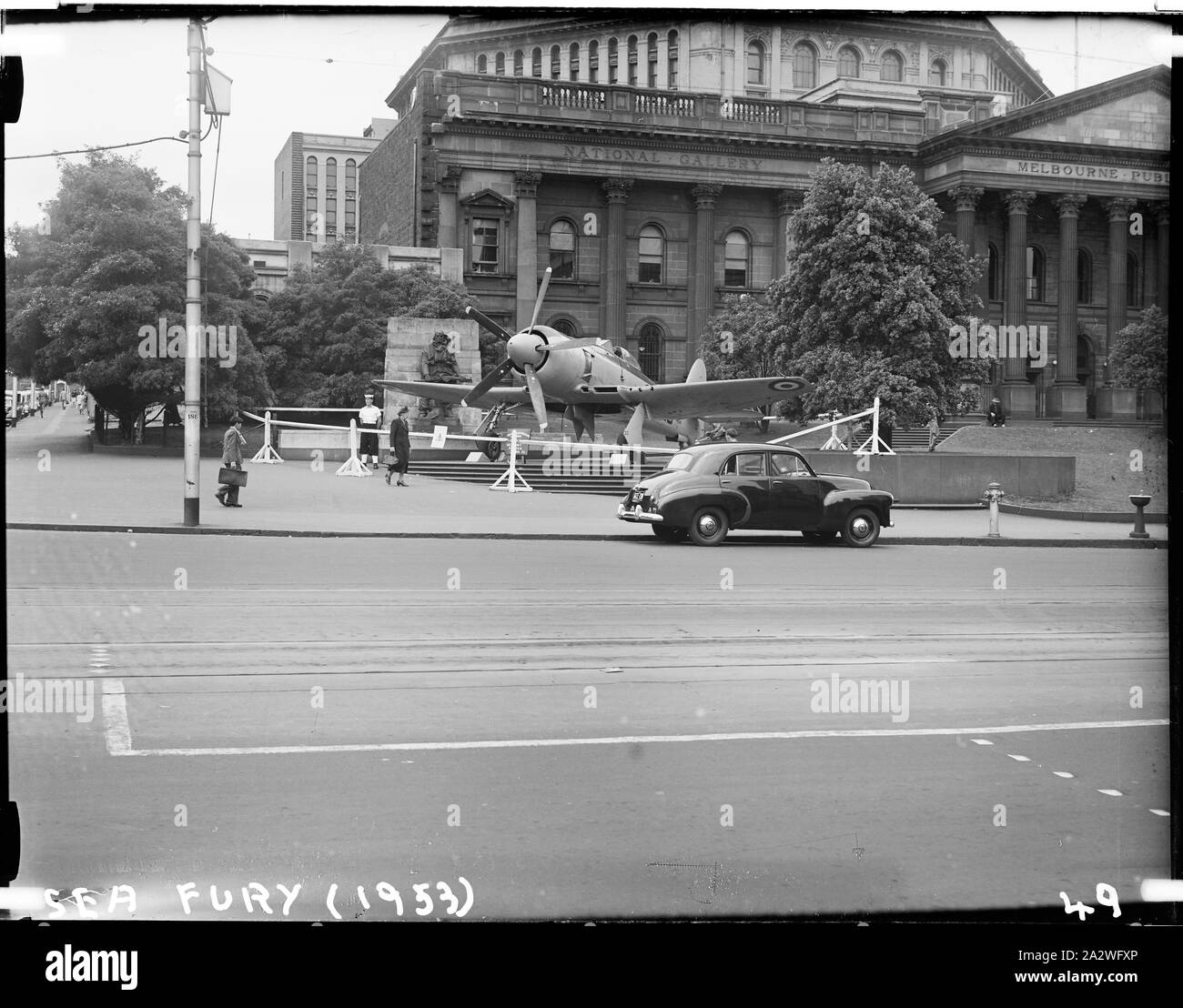 Glass Negative - Sea Fury Military Bomber Aircraft at the Jubilee of Flight Exhibition, Museum of Applied Science of Victoria (Science Museum), Melbourne, 1953, Photograph of the Royal Australian Navy's Sea Fury Military Bomber Aircraft outside the Museum of Applied Science, Swanston Street, 1953. The Sea Fury was loaned to the Museum for its Jubilee of Flight Exhibition, which commemorated fifty years of aviation. The exhibition was open to the public from Dec 10 1953 until Feb 1954 Stock Photo