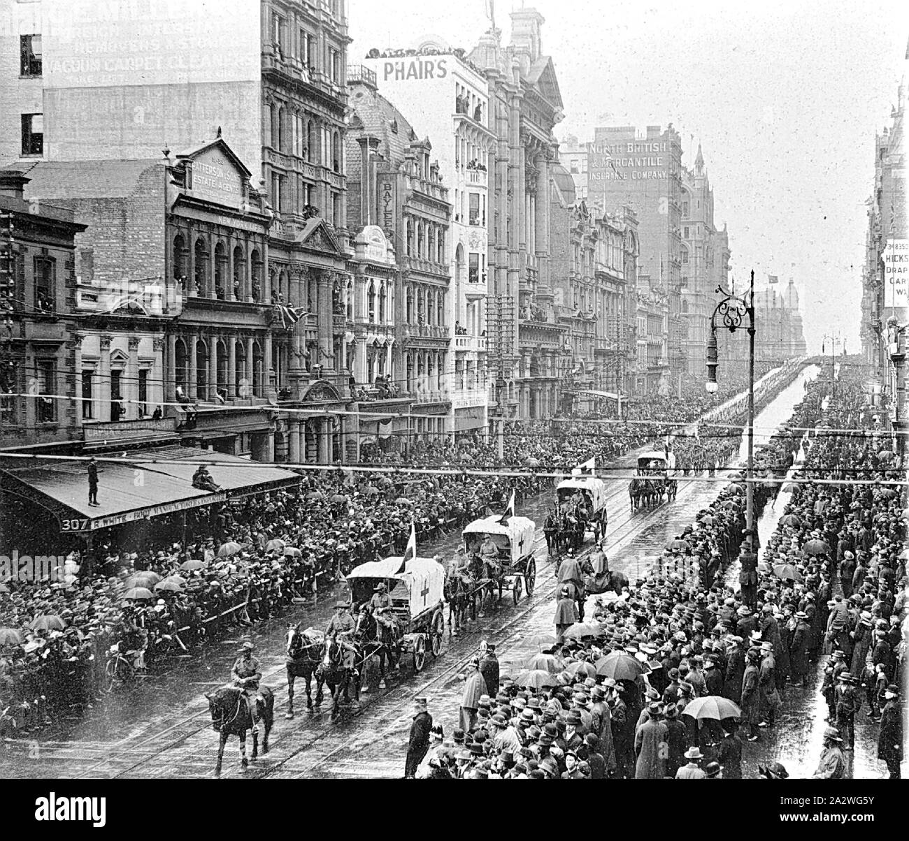 Negative - Horse Drawn Ambulances Leading a Parade of Soldiers, Swanston Street, Melbourne, Victoria, 1914, Horse-drawn ambulances leading a parade of soldiers Stock Photo