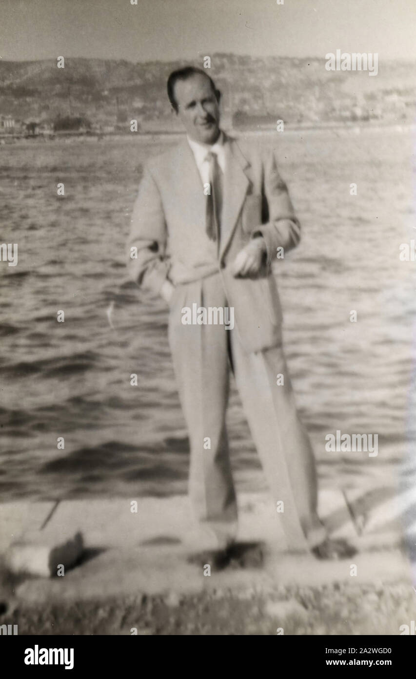 Photograph - James Leech Standing on Water's Edge, Frankston, circa 1954, Photograph of James Leech standing on the water's edge, possibly in Frankston, Melbourne, circa 1954. James had migrated with his wife Eileen and daughter Susan Leech to Melbourne from England in 1953 and they returned to England in 1956. James and Eileen Leech and their two and a half year old daughter Susan migrated from Manchester, England in November 1953 under the ten pound assisted Stock Photo