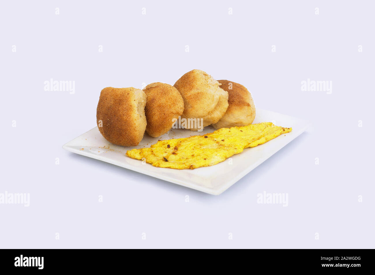 Typical Filipino Breakfast, Pandesal Crusted Bread and Scrambled Egg on a plate. Stock Photo