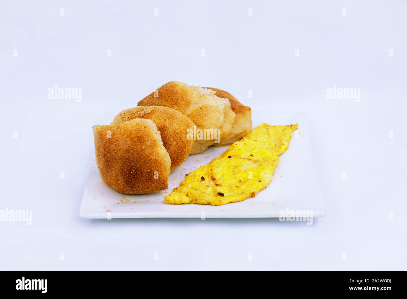 Typical Filipino Breakfast, Pandesal Crusted Bread and Scrambled Egg on a plate. Stock Photo