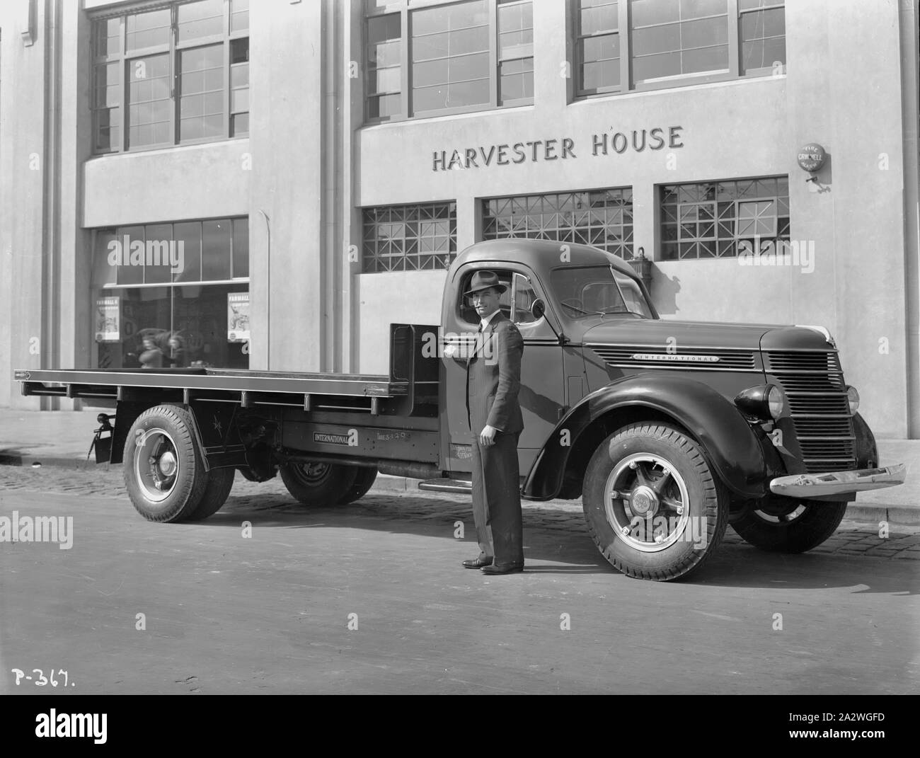 Negative - International Harvester, Keith Rigg & D40 Truck Outside Harvester House, City Road, South Melbourne, 1940, Part of a large collection of glass plate and film negatives, transparencies, photo albums, product catalogues, videos, motion picture films, company journals, advertisements and newspaper cuttings relating to the operations of the International Harvester Company and its subsidiaries in Australia. The International Harvester Company of America was formed in 1902 by the merger of five leading Stock Photo