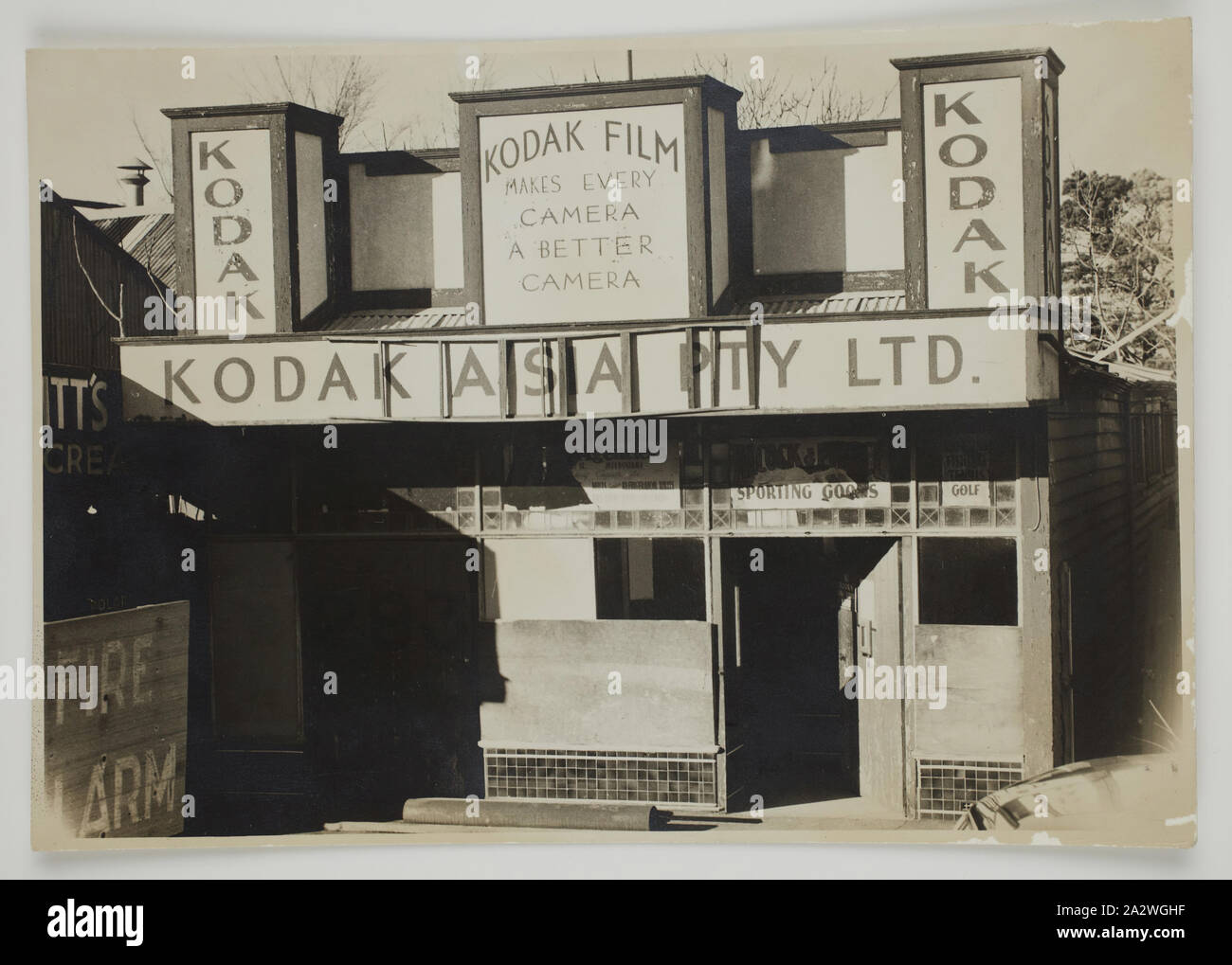 Photograph, Empty Store Front, Monochrome photograph of a boarded up Kodak store displaying the old 'Kodak Film Makes Every Camera A Better Camera' 1930s era signs. This group is part of the Kodak collection of products, promotional materials, photographs and working life artefacts, when the Melbourne manufacturing plant at Coburg closed down. manufactured and distributed a wide Stock Photo