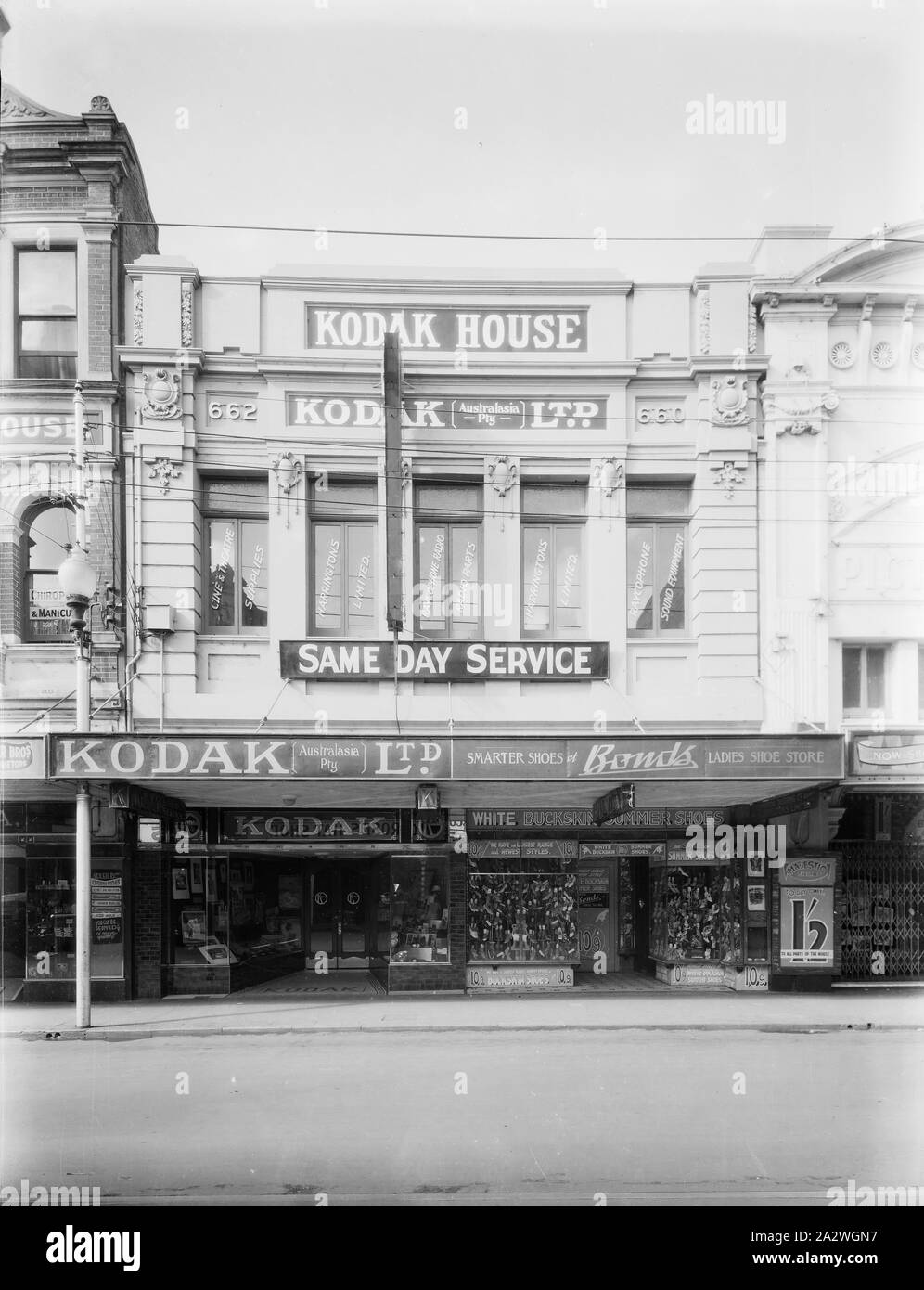 Negative, Shop Exterior, Perth, Western Australia, circa 1935, Black and white film negative of the Kodak Australasia Pty Ltd branch store at 662 Hay Street, Perth, Western Australia, taken circa 1935. This street view shows the shop front displays of photographs and photographic products the Kodak shop, and the windows of neighbouring shops. collection of products, promotional materials, photographs and working life artefacts Stock Photo