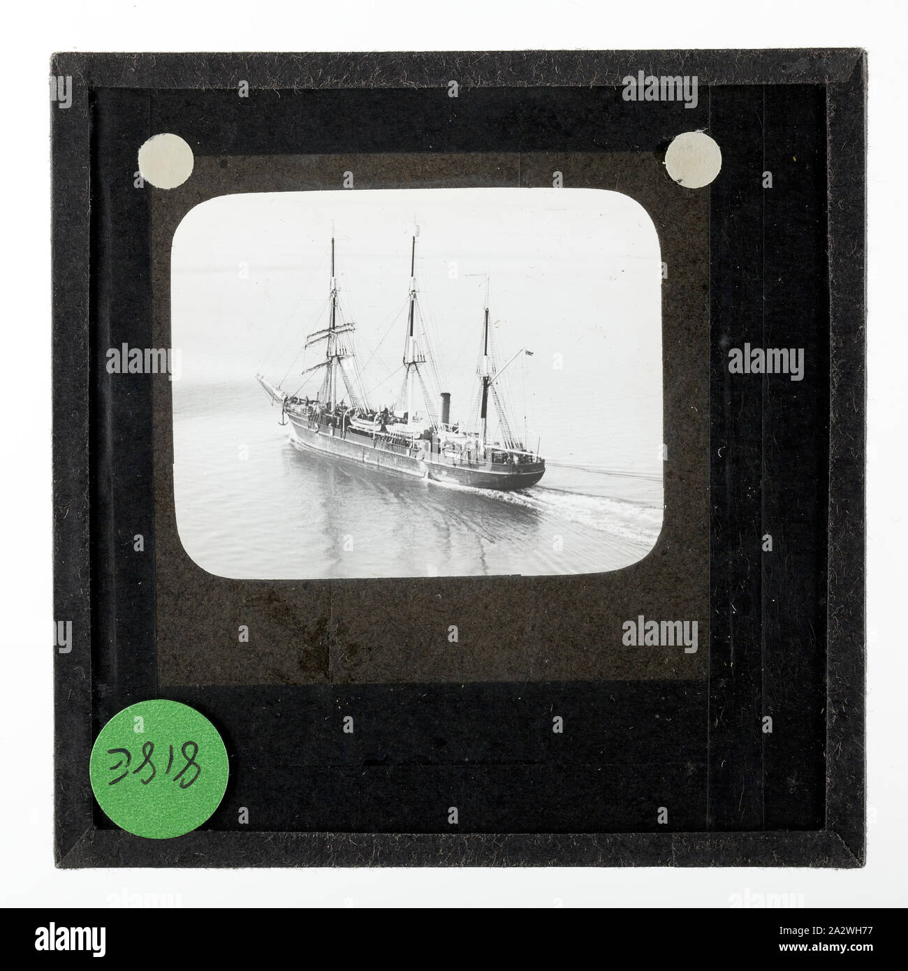 Lantern Slide - An Aerial View of the Discovery Steaming Along in Open Water, BANZARE Voyage 2, Antarctica, 1930-1931, Lantern slide of an aerial view of the ship Discovery in open waters. One of 328 images in various formats including artworks, photographs, glass negatives and lantern slides Stock Photo
