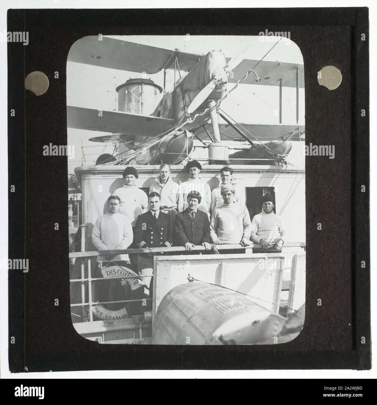 Lantern Slide - Crew with Lieutenant Hill & Ellsworth. Ellsworth Relief Expedition, Discovery II, Antarctica, 1936, Lantern slide of the crew aboard the Discovery II, Ellsworth Relief Expedition, Antarctica. One of 328 images in various formats including artworks, photographs, glass negatives and lantern slides Stock Photo