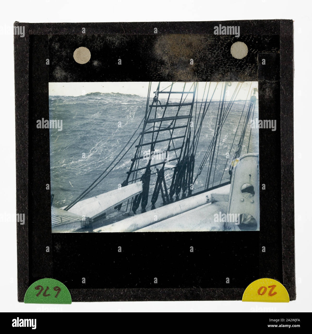 Lantern Slide - Ship Discovery on the Return Journey to Hobart, BANZARE Voyage 2, Antarctica, 1930-1931, Lantern slide of the Discovery in an ocean swell during the return trip from the Antarctic to Hobart. One of 328 images in various formats including artworks, photographs, glass negatives and lantern slides Stock Photo