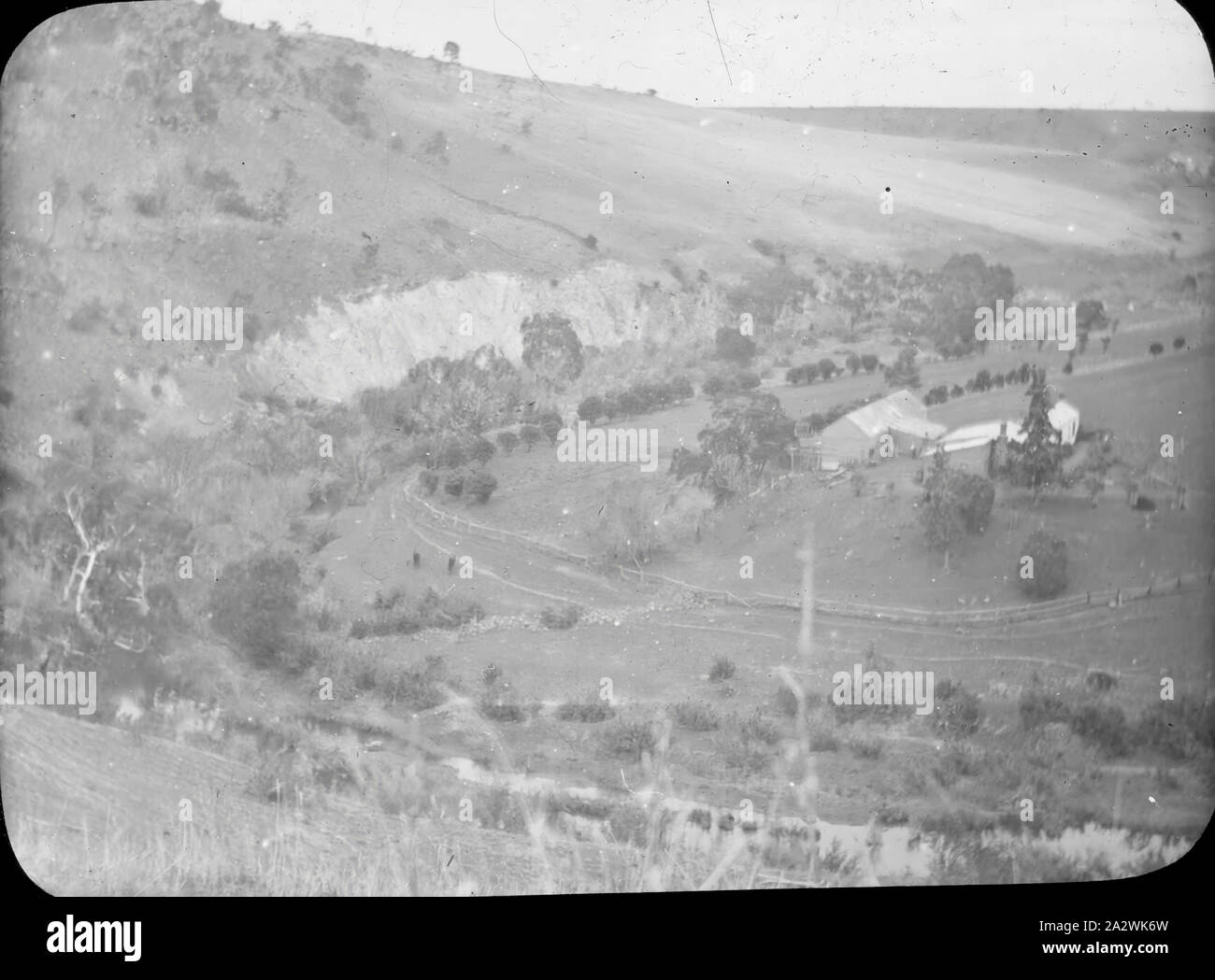 Lantern Slide - Werribee River, Victoria, Date Unknown, Black and white image of a farm established on the bend of the valley created by Werribee River, photographed by A.J. Campbell Stock Photo