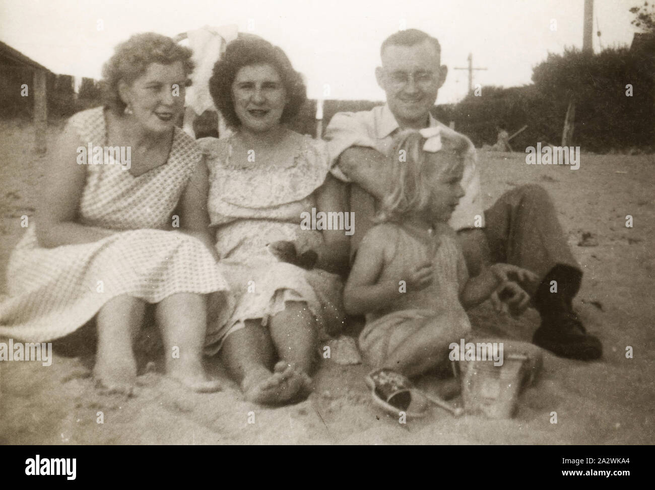 Photograph - Leech Family at Beach, Melbourne, circa 1954, Photograph of Eileen Leech (centre) with Aunt Flo and Uncle Laurence and her daughter Susan at the beach, possibly in Frankston, Melbourne, circa 1954. Eileen, James and Susan Leech had migrated to Melbourne from England in 1953 and they returned to England in 1956. James and Eileen Leech and their two and a half year old daughter Susan migrated from Manchester, England in November 1953 under Stock Photo
