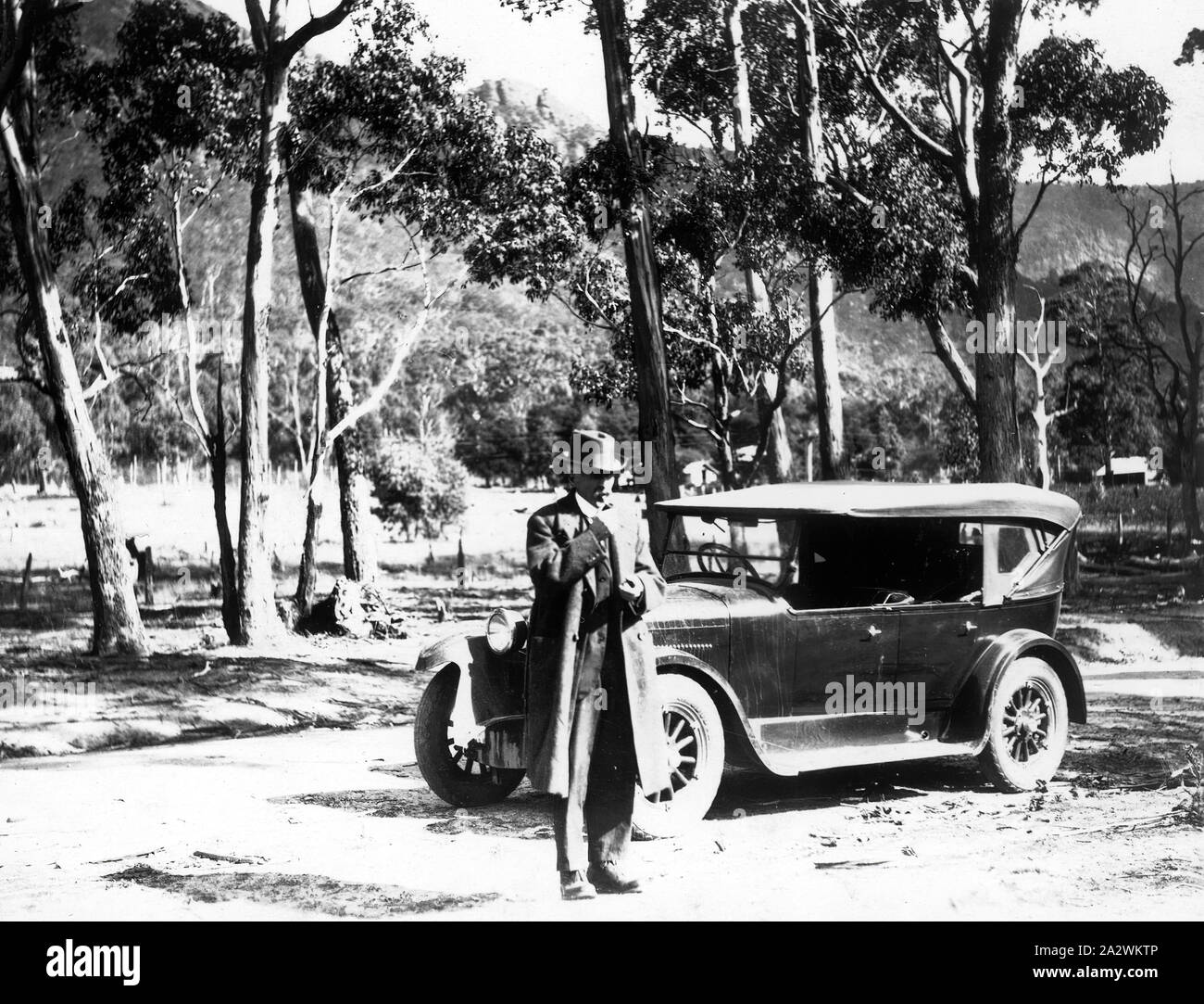 Photograph - by Jack Walton, Grampians, Victoria, circa 1920s-1930s, Man standing in front of a motor car Stock Photo