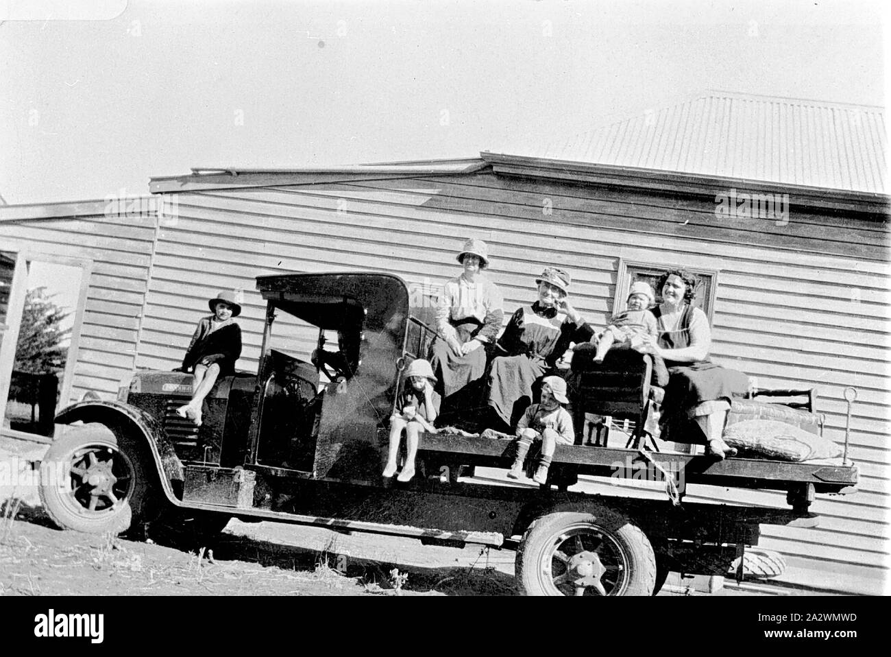 Negative - Women & Children Sitting on a Brockway Truck, Karoonda, South Australia, circa 1925, Women and children sitting on a Brockway truck Stock Photo