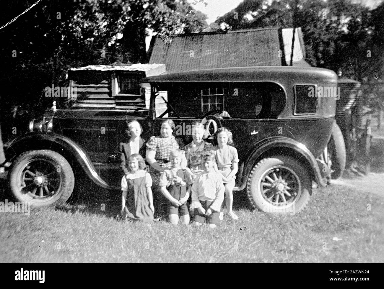 Negative - Murphy Family Seated on the Running Board of their Studebaker Car, Creswick, Victoria, circa 1930, The Murphy family seated on the running board of their Studebaker car Stock Photo