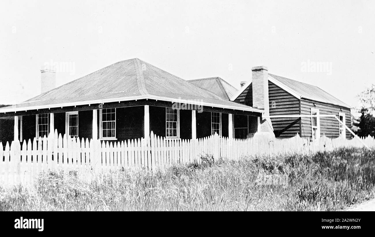 Negative - House With Verandah, Mount Lonarch, Victoria, circa 1935, A house with verandah and with extensions to the back. There is tall grass in front of the picket fence Stock Photo