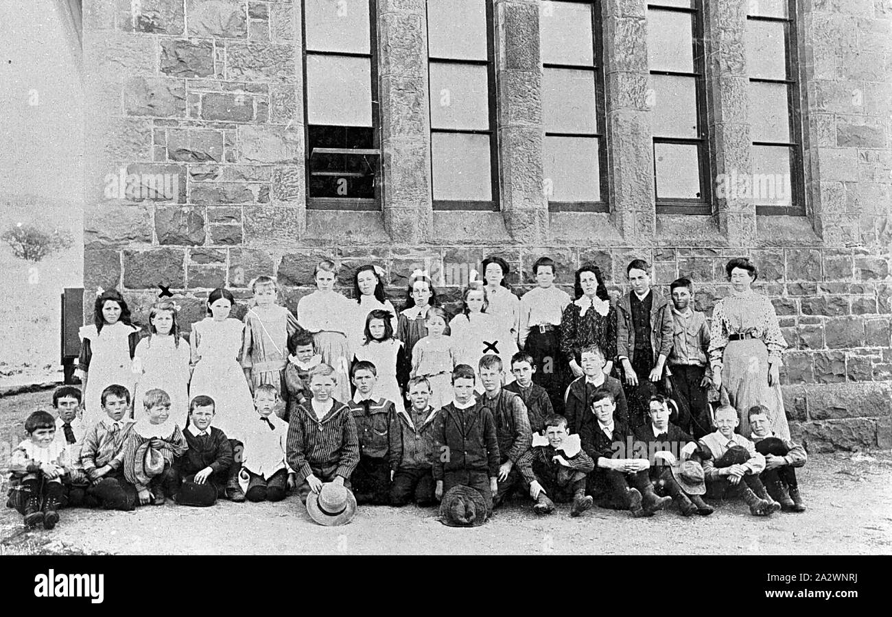 Negative - Skipton, Victoria, circa 1885, Children and their teacher outside the Old Common School, Skipton. It is a large stone building Stock Photo