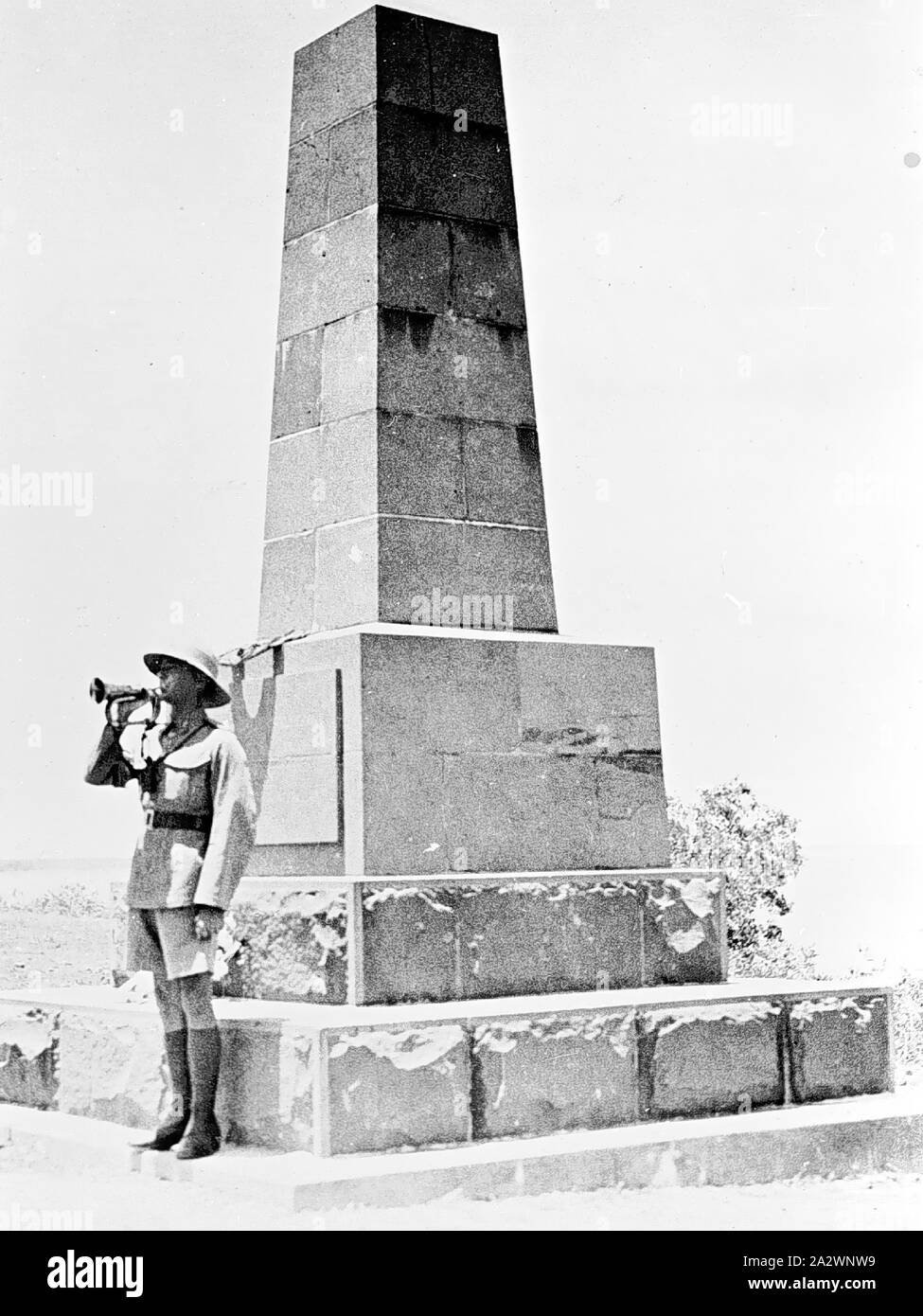 Negative - Darwin, Northern Territory, Nov 1933, Sounding the 'Last Post' on Armistice Day. The soldier, Gunner Dance, is standing by the Ross Smith Memorial at Fanny Bay. The memorial commemorates the feat of Ross and Keith Smith in completing the first flight from England to Australia Stock Photo
