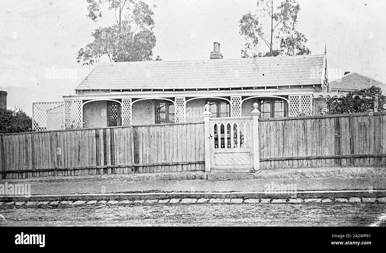 Negative - Richmond, Victoria, circa 1885, A small suburban house behind a paling fence. There are trellises along the verandah and bluestone blocks along the gutter Stock Photo