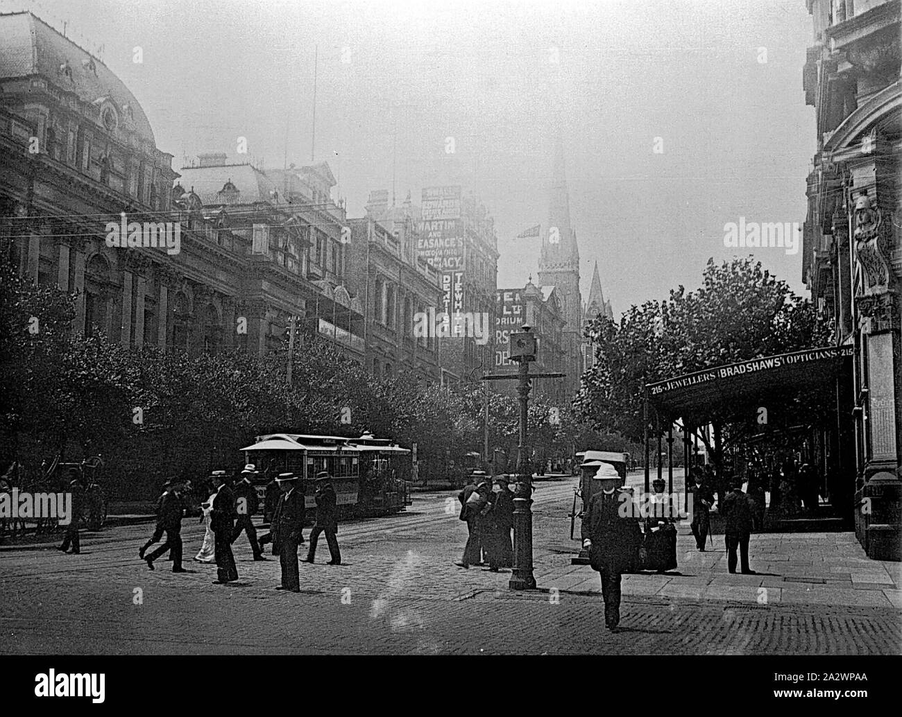 Negative - Melbourne, Victoria, circa 1900, Looking east along Collins Street from the corner with Swanston Street. The Melbourne Town Hall is on the left and a cable tram is travelling along Collins Street. Bradshaws, Opticians is on the right and the spires of Scots Church and the Presbyterian Church Stock Photo