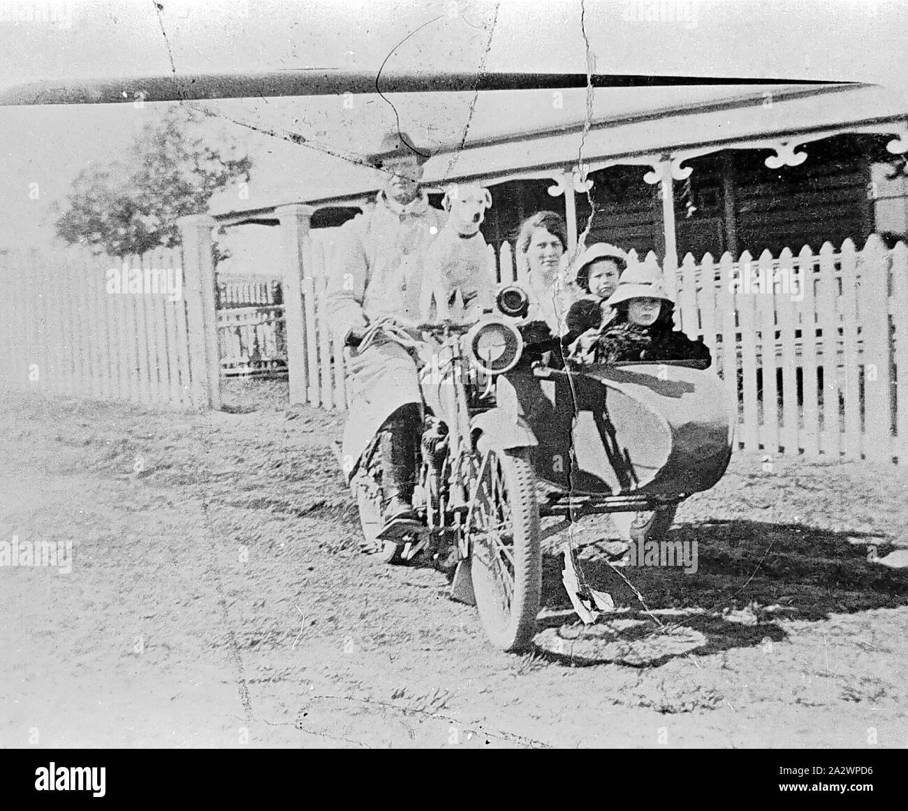 Negative - Stroud, New South Wales, 1919, A Baptist minister, his daughters and his sister in a motorbike and sidecar. A dog sits on the front of the bike. The Baptist manse is in the background Stock Photo