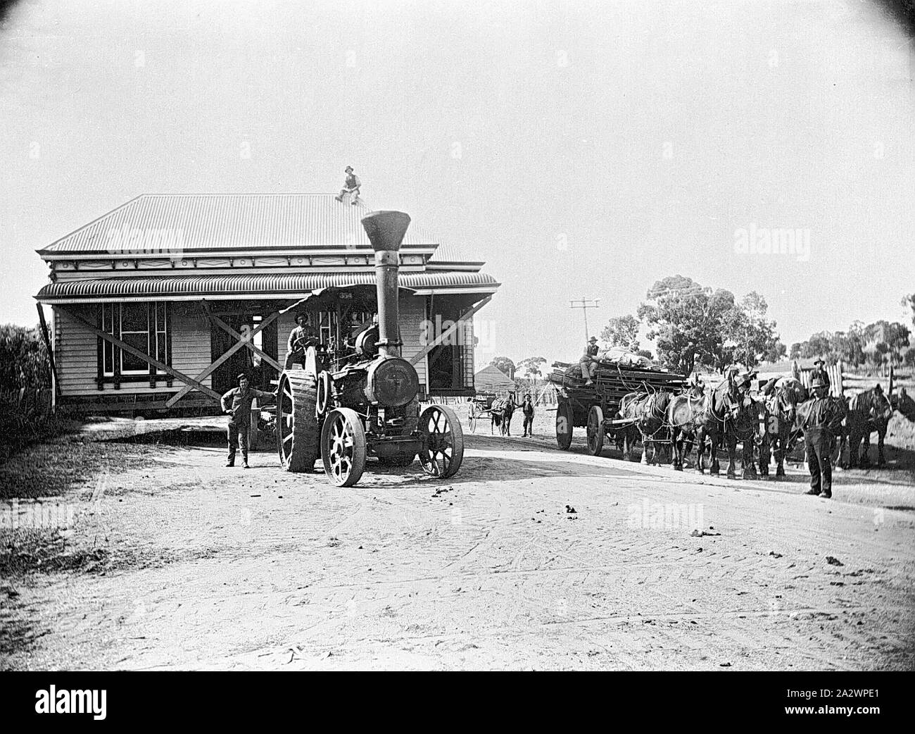 Negative St Arnaud, Victoria, circa 1915, A house being moved by tractor. A man is sitting on