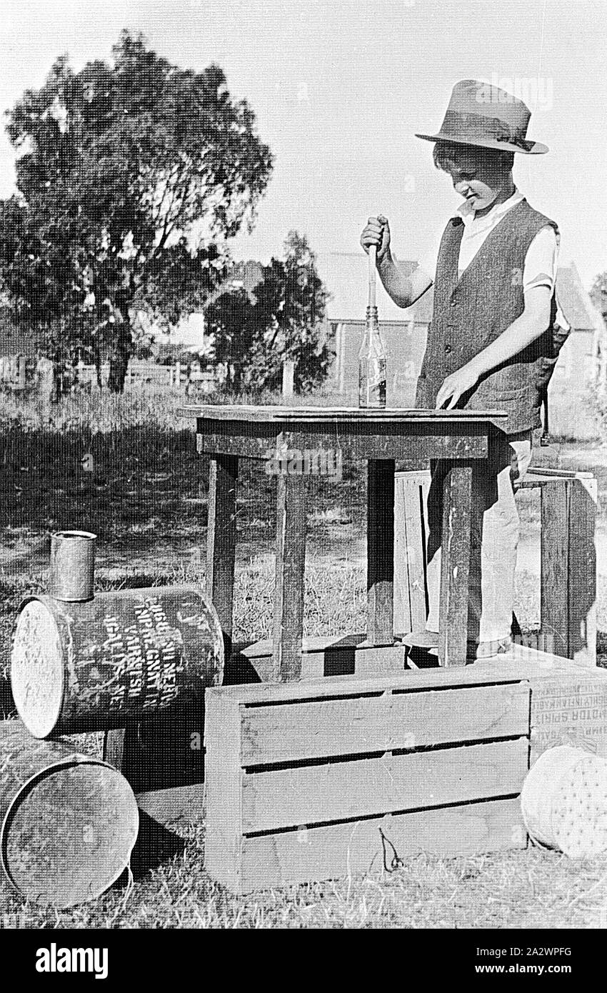Negative - Greensborough, Victoria, 1933, A boy playing with a 'train' constructed from a table, crates , fuel drums and cans Stock Photo