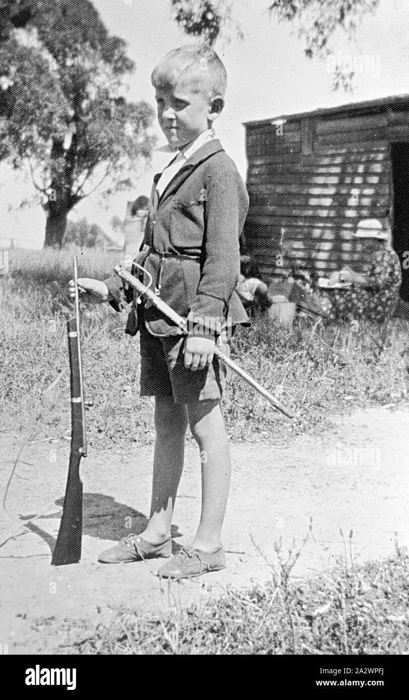 Negative - Greensborough, Victoria, 1933, A young boy with a toy sword and rifle Stock Photo