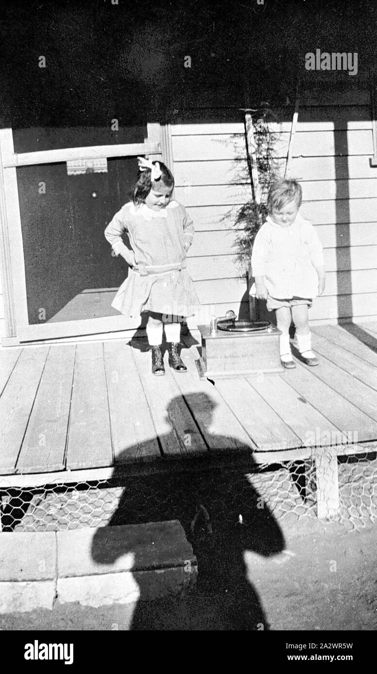 Negative - Prooinga, Victoria, 1932, Two small girls on a verandah, they are dancing to a record player Stock Photo