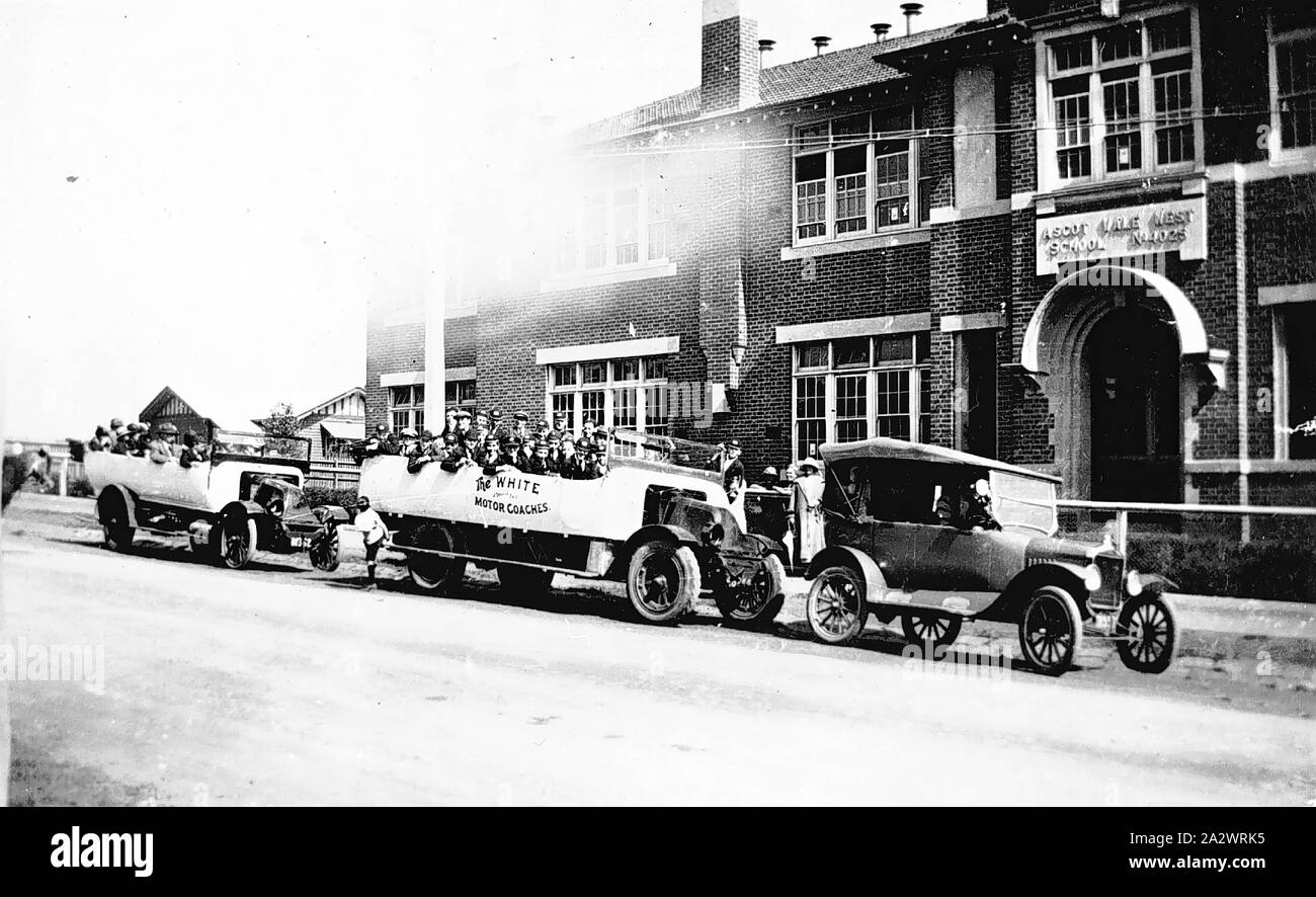 Negative - Ascot Vale West, Victoria, 1925, Boys from the Ascot West State School, No.4025, on a coach trip to Tecoma. They are seated in charabancs belonging to the White Motor Coaches. The boys were sent on the trip by the school committee and friends as a reward. The motor car on the right is a Model T Ford Stock Photo