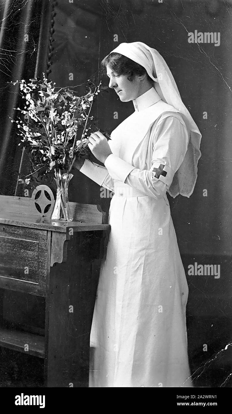 Negative - Woman in Red Cross Uniform, Nareen, Victoria, circa 1914-1918, Photograph of a woman wearing the uniform of a Voluntary Aid Detachment (VAD) nurse's apron and veil, with a red cross on an armband, apparently taken at Nareen, Victoria. Although the photograph is dated to 1905, the Australian branch of the Red Cross was only established in 1914, so the photograph is unlikely to date from 1905, and is more likely to have been taken during World War I Stock Photo