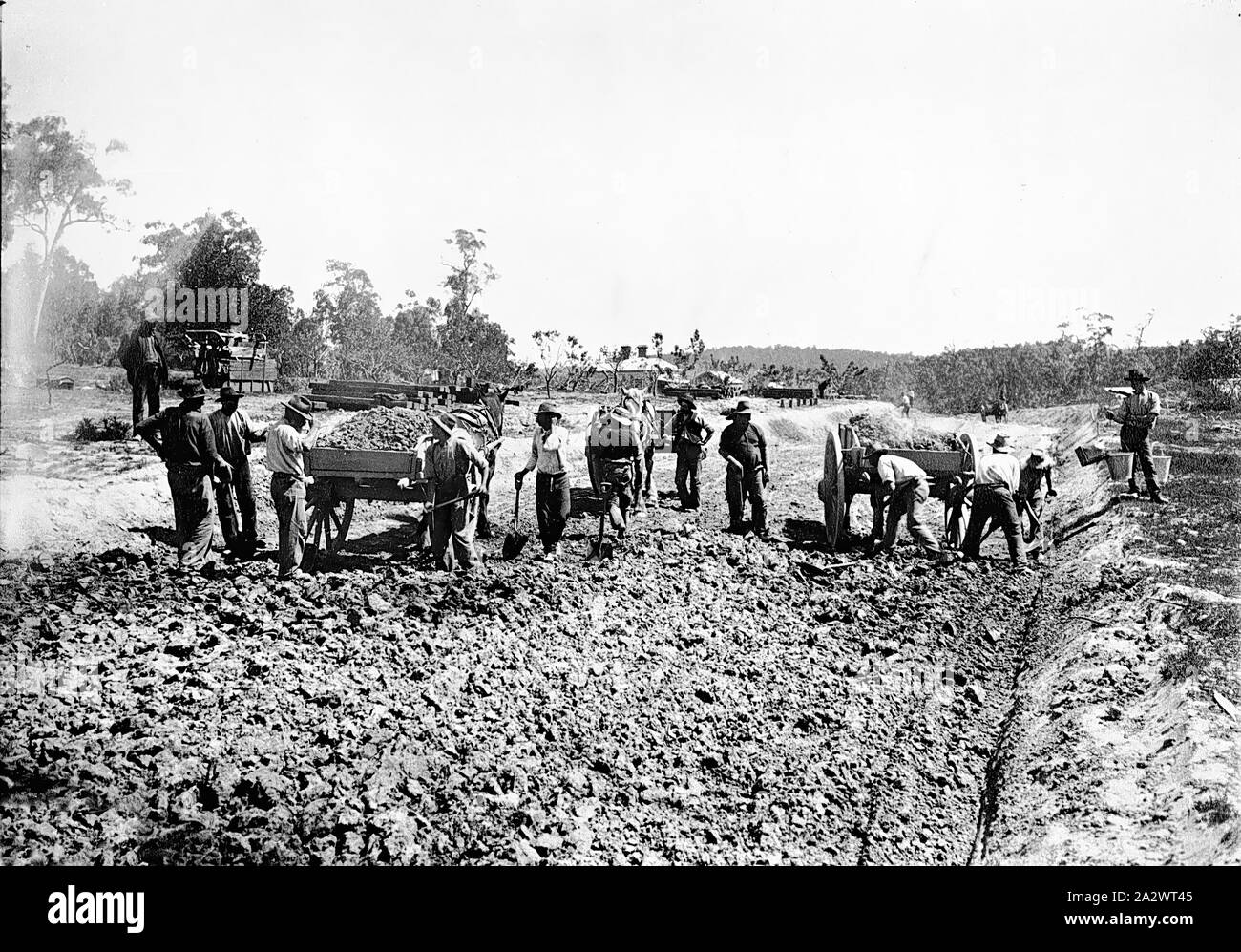 Negative - Hurstbridge District, Victoria, circa 1905, Workmen building the railway line to Hurstbridge. Men are standing around a cart to the left while others to the right lay tracks Stock Photo