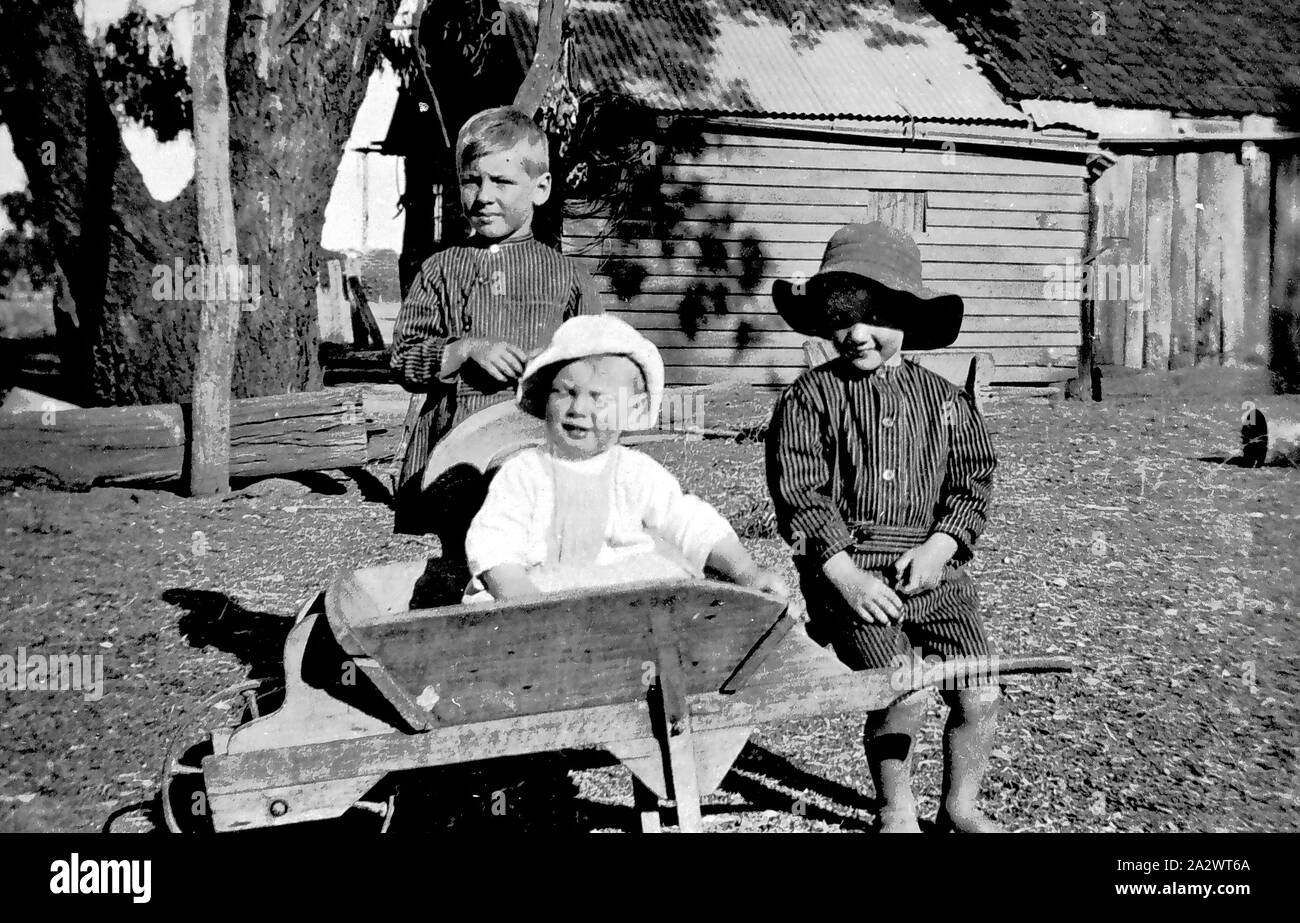 Negative - Diggora, Victoria, circa 1920, Black and white photograph featuring Rob, Ivan and Garn Haines, in the farmyard at 'Hazeldene' farm circa 1920 Stock Photo