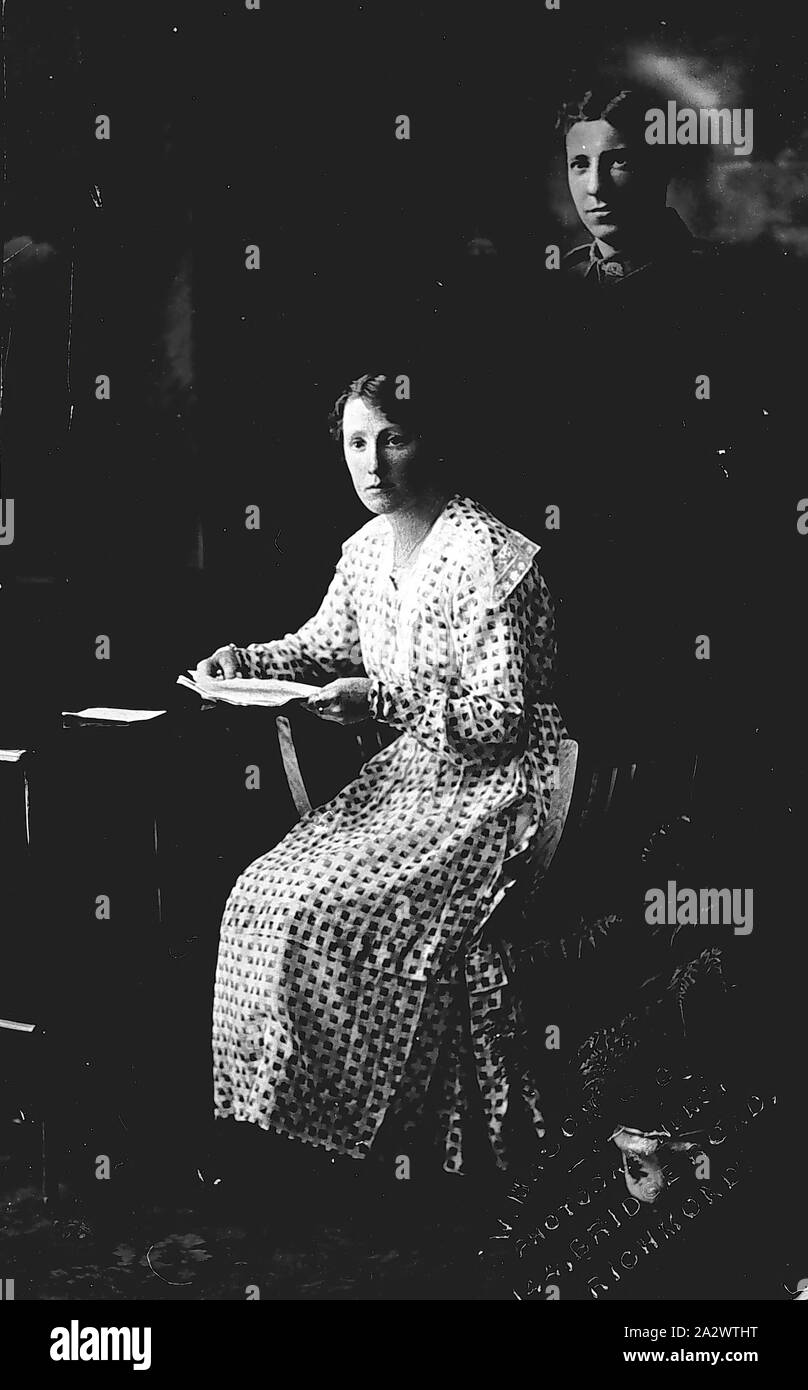 Negative - Richmond, Victoria, 1915, A women writing a letter. There is the image of a soldier in top corner Stock Photo