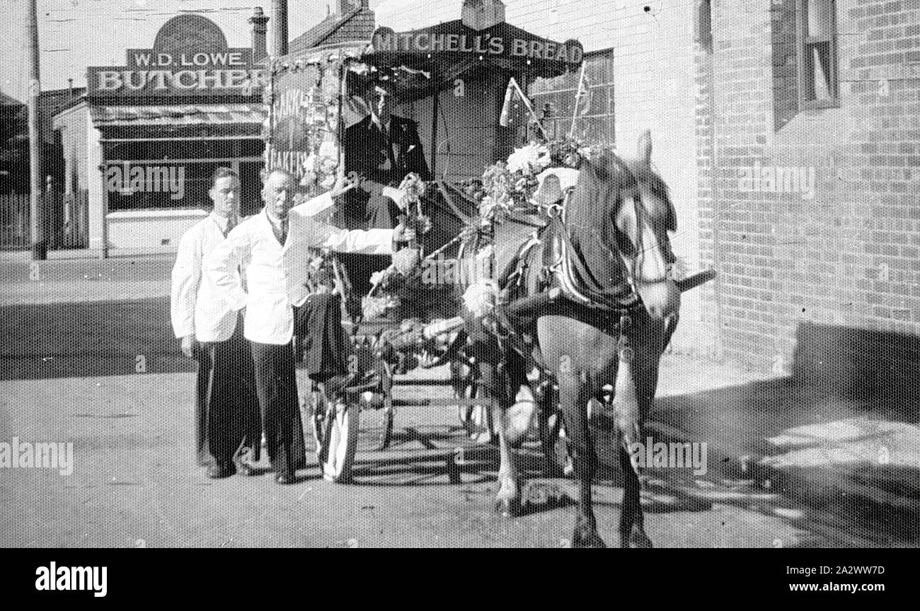 Negative - Decorated Horse Cart, Footscray, Victoria, 1939, Three men with the float judged best in the Footscray Gymkhana of 1939 the float was entered by Mitchell's Bread. The shop of W.D.Lowe, Butcher is in the background Stock Photo
