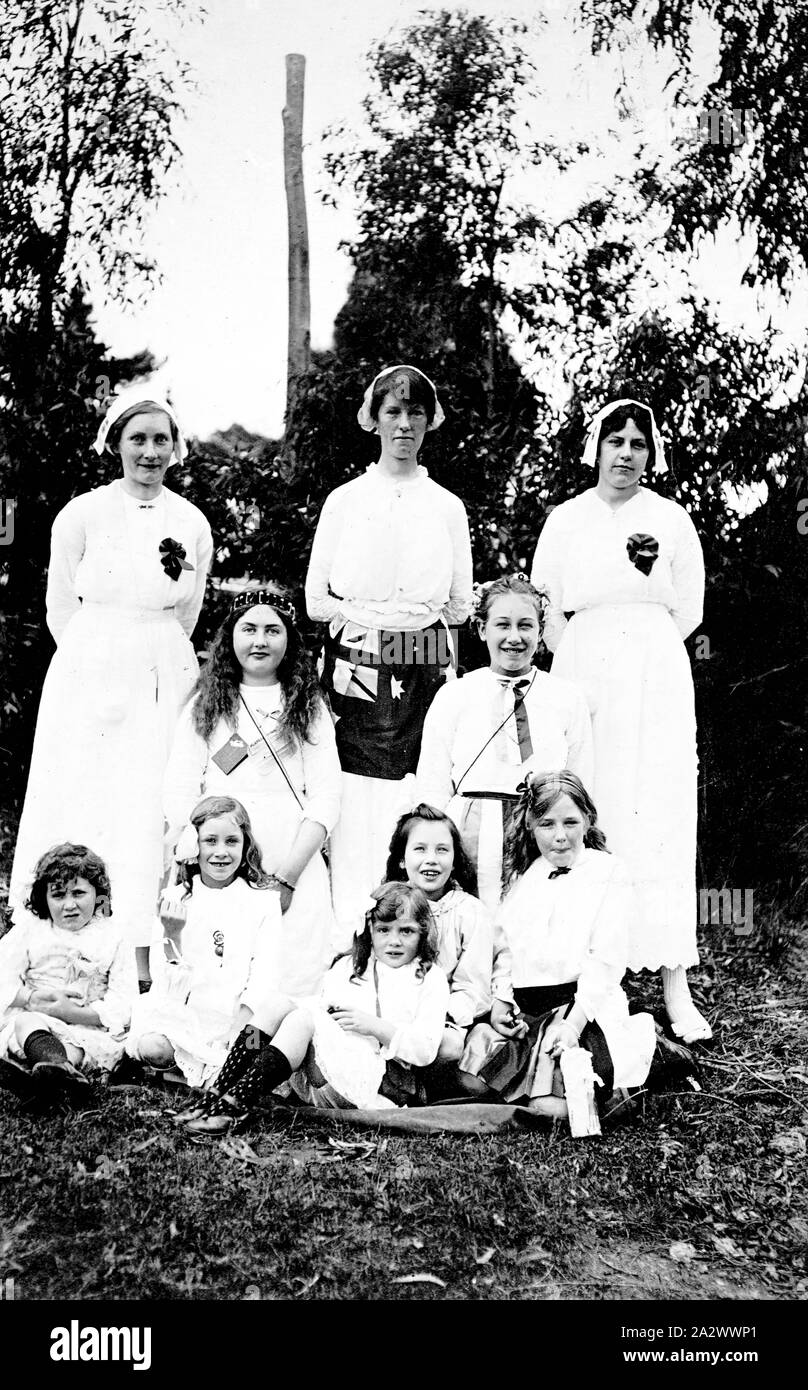 Negative - Victoria, circa 1915, Three women in nurses ' uniforms with a group of small children. One woman is wearing a flag around her waist Stock Photo