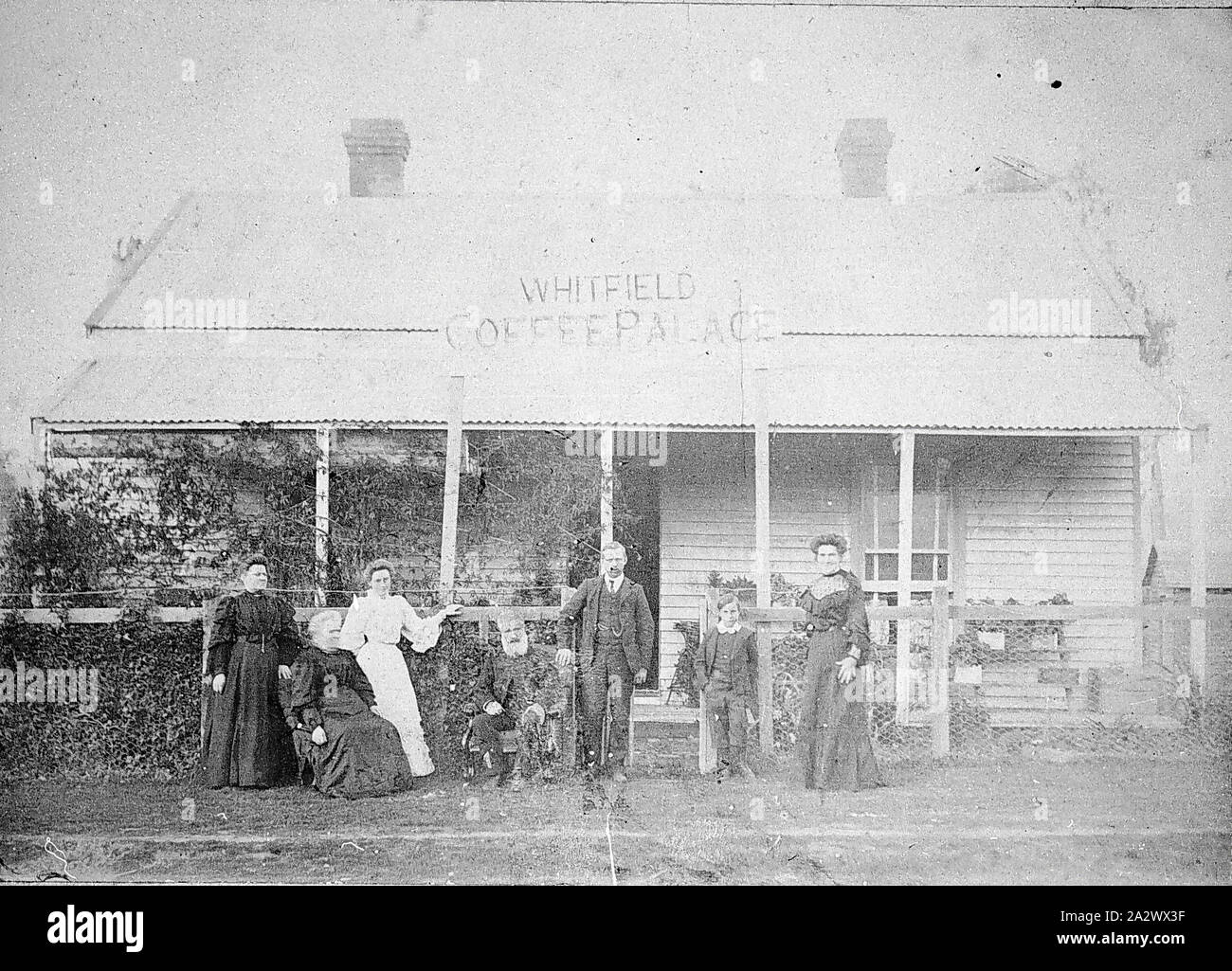 Negative - Whitfield, Victoria, circa 1905, A family group in front of the Whitfield Coffee Palace. It is a weatherboard building, two brick chimneys with a verandah across the front. It is fenced with posts and wire netting Stock Photo