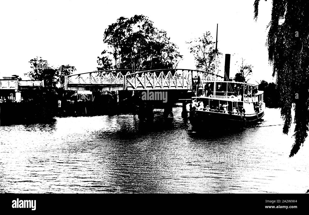 Negative - Sale Steamboat Company's SS Omeo Passing the Swing Bridge, Sale District, Victoria, circa 1910, The passenger steamer 'Omeo' passing the Swing Bridge on the Latrobe River at Longford, near Sale, which has opened to allow the vessel to pass through. The Omeo was operated by the Lakes Navigation Company from 1885-1890, and then its successor the Sale Steamboat Company from 1890-1929. In 1929, the Omeo was hulked and broken up for scrap on the Thomson River at Sale after being severely damaged Stock Photo