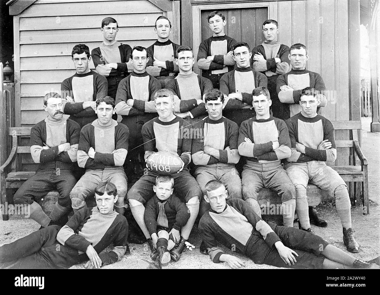 Negative Geelong, Victoria, 1908, A football team. The man in the
