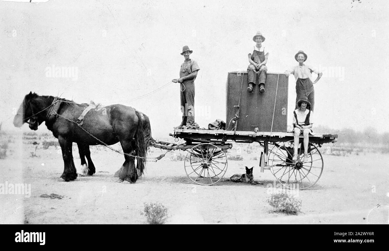 Negative - Cootamundra District, New South Wales, 1928, The Fox family carting water. They had to provide water for 80 cows. They have a large water tank strapped on the back of a dray and one of them is sitting on top of the tank Stock Photo