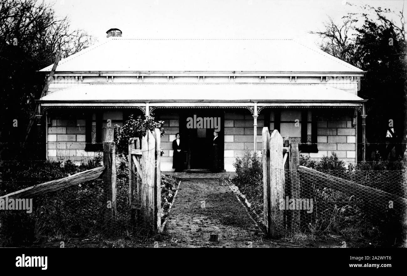 Negative - Graham Family Farm House, Wandin, Victoria, circa 1915, Black and white negative of the Graham family house at their farm in Queens Road in Wandin, circa 1915. In the doorway of the house are, at right, Mrs Mary Jane Graham, nee Russell the donor's grandmother, and at left, Miss Minnie Graham, the donor's aunt. This farm was a small orchard property that was taken on by the family after the donor's grandmother, Mrs Mary Jane Graham, retired from her Stock Photo