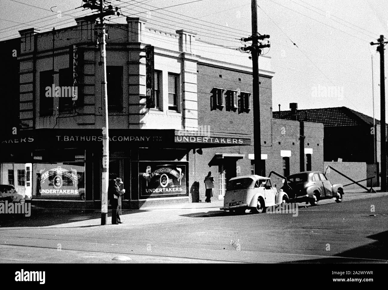 Negative - Caulfield South, Victoria, circa 1955, T. Bathurst & Company Proprietary Limited, Undertakers. There are cars parked by the side of the road and tram tracks in the foreground Stock Photo