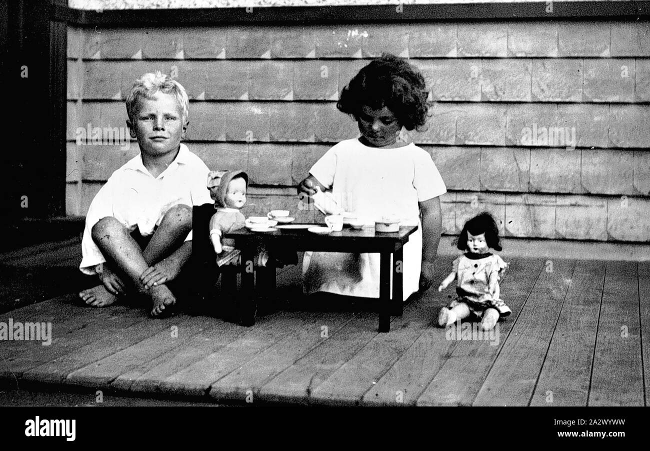 Negative - Carnegie, Victoria, 1926, A small boy and girl playing with dolls Stock Photo
