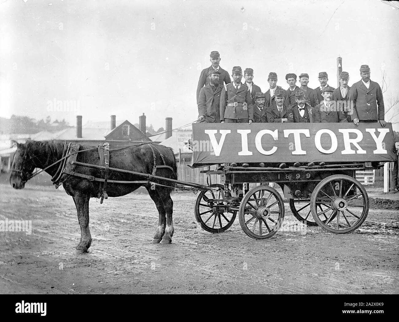 Negative - Casterton, Victoria, 1900, Members of the Casterton horse-drawn fire brigade with a banner on their carriage celebrating the Relief of Mafeking. The banner reads: 'Victory Stock Photo
