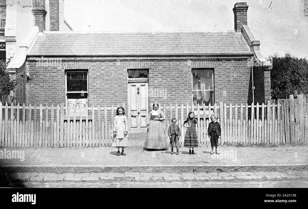Negative - Family in Front of Home, Melbourne, Victoria, circa 1860s, The photograph was originally dated circa 1880, but the clothing worn strongly suggests an earlier date, likely to be the 1860s Stock Photo