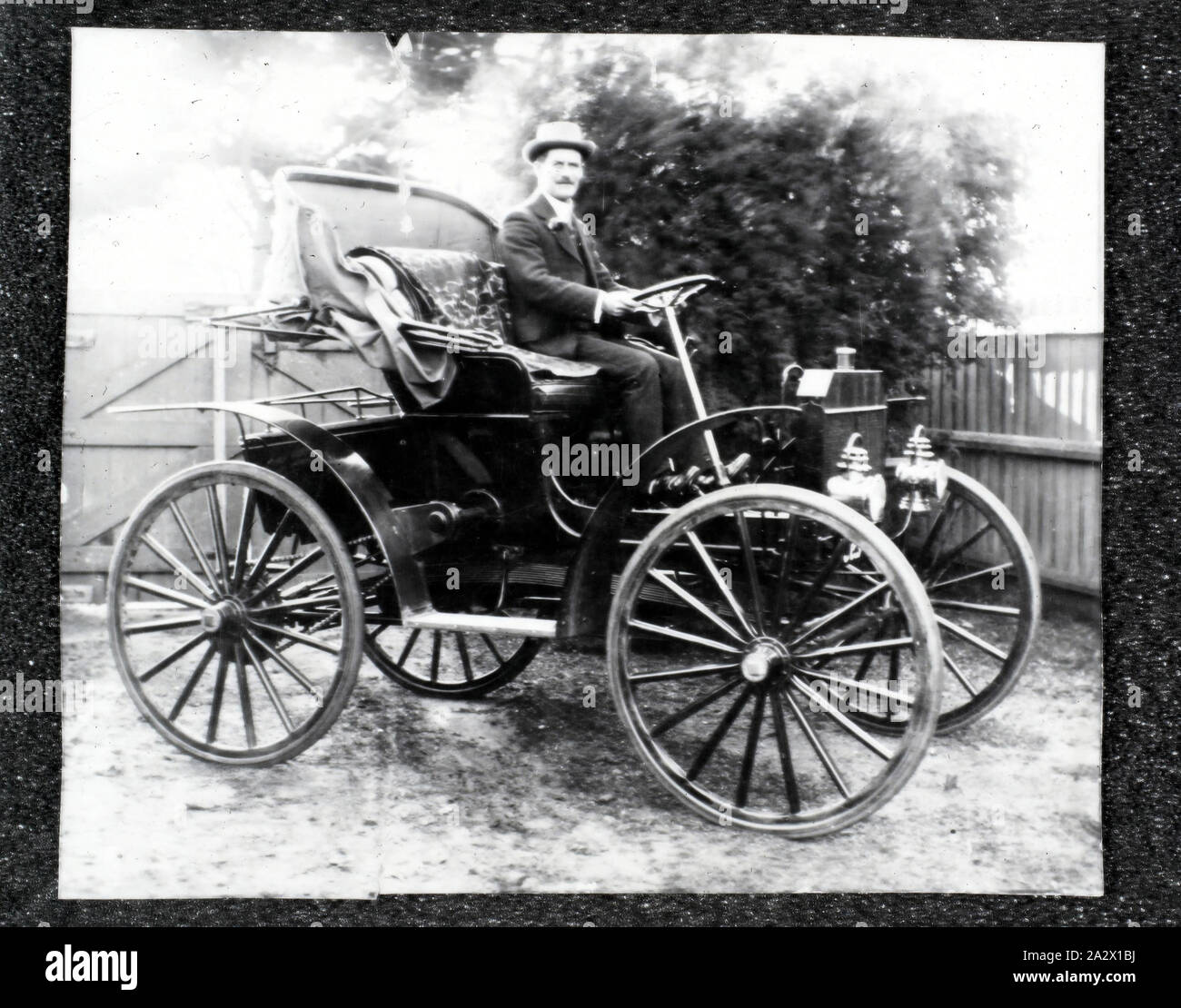 Negative - Thomas M. Arthur & Schacht Motor Buggy, Melbourne, Victoria, circa 1908-1909, Black and white negative of Mr Thomas Montgomery Arthur sitting in a motor buggy, circa 1908-1909. Mr Thomas Montgomery Arthur was a commercial traveler for Henry Berry (Grocers) in Melbourne. The Schacht company produced this type of motor buggy in Cincinnati, Ohio, USA between 1905 and 1909. This image is part of a collection of photographs, negatives and slides used for research by curators at Stock Photo