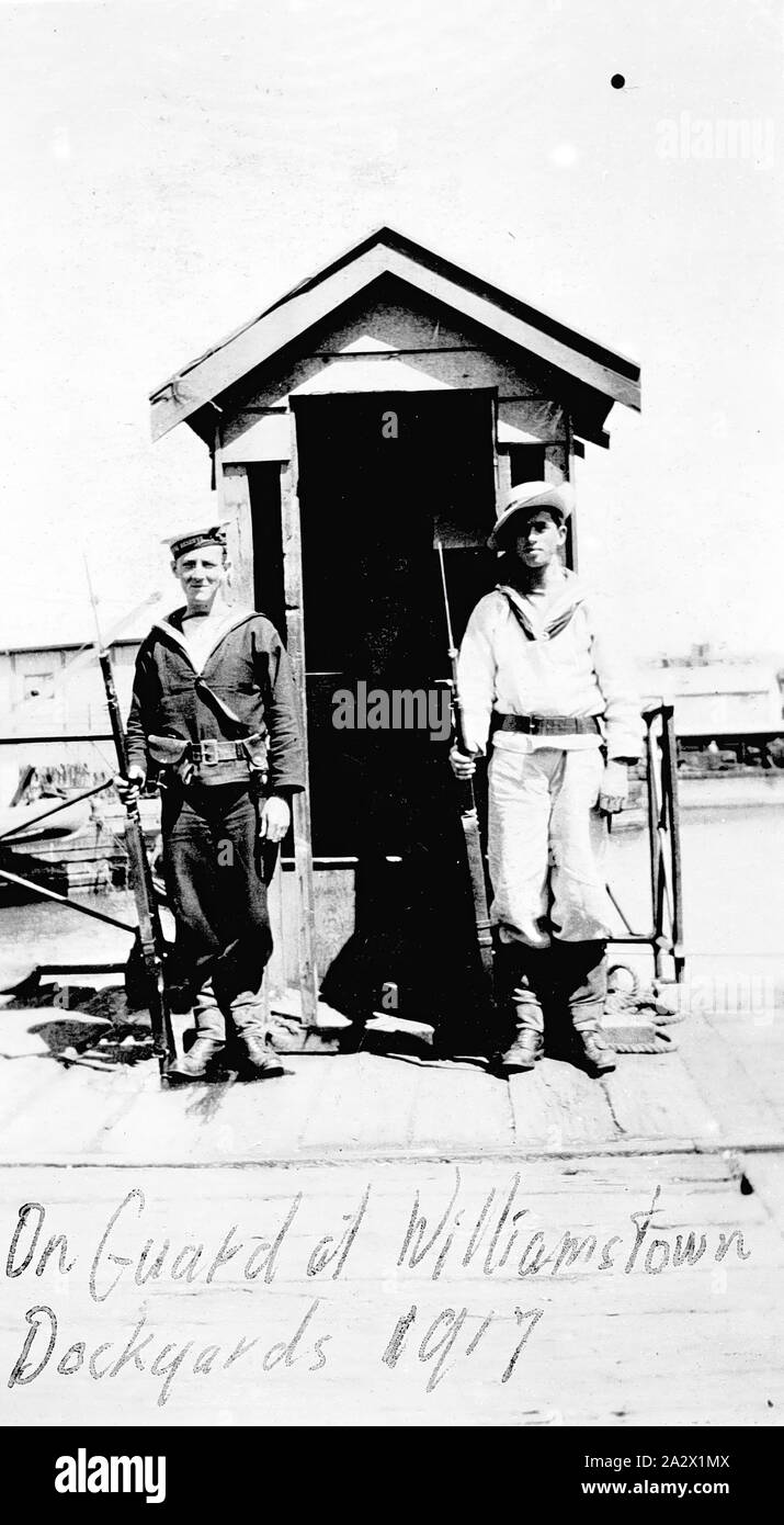 Negative - Williamstown, Victoria, 1917, Sailors on guard duty at Williamstown Dockyard. One is wearing summer uniform. Both are holding rifles with fixed bayonets Stock Photo