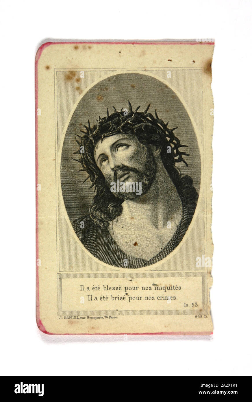 Page - Jesus, 'Il a Ete Blesse Pour Nos Iniquites', Likely World War I, 1916-1918, Alternative Name(s): Book Fragment, Card Page with illustration of Jesus with crown of thorns, apparently torn from a bible written in French. It is inscribed 'Il a ete blesse pour nos iniquites / Il a ete brise pour nos crimes' - translates roughly as 'He was wounded for our wickedness / He was broken for our wickedness'. Its likely owner was World War I soldier Private William Nairn, a deeply Stock Photo